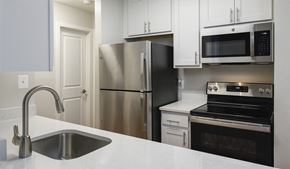 Germantown apartment for rent - Kitchen with granite-style counters, stainless steel appliances, and shaker-style cabinets at Stonecreek Club in Germantown, MD