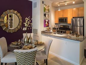 Rockville apartment for rent - a dining room table with chairs next to a kitchen