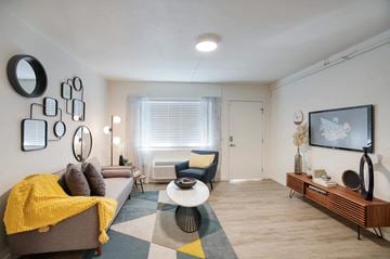 Tucson apartment for rent - a living room with a couch and a tv at Presidio Palms Apartments, Arizona , 85701