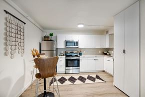Tucson apartment for rent - a kitchen with white cabinets and stainless steel appliances at Presidio Palms Apartments, Tucson, AZ, 85701