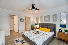 Tucson apartment for rent - a bedroom with a bed and a ceiling fan at Presidio Palms Apartments, Tucson