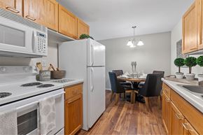Bloomington apartment for rent - kitchen and dining room with white fridge