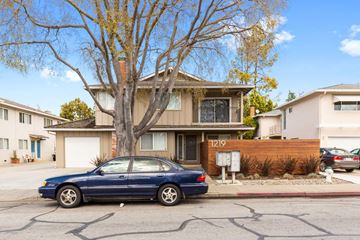 Sunnyvale apartment for rent - A blue car is parked in front of a house with the number 129 on it.