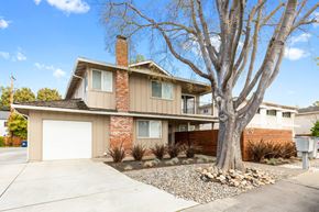 Sunnyvale apartment for rent - A house with a brown brick chimney and a white garage door.