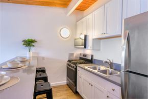 Goleta apartment for rent - A kitchen with white cabinets and stainless steel appliances.