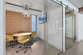 Los Angeles apartment for rent - A conference room with a glass wall and yellow chairs.