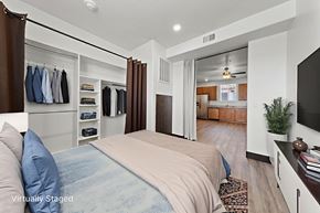 Mesquite apartment for rent - A bedroom with a bed, a TV, and a wardrobe.