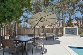 Newbury Park apartment for rent - A patio with a table and chairs under an umbrella.