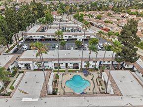 Camarillo apartment for rent - A swimming pool in the middle of a courtyard surrounded by buildings.