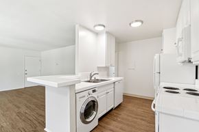 Camarillo apartment for rent - A white kitchen with a washing machine and a stove.
