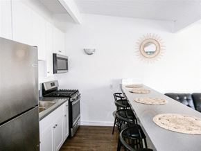 Goleta apartment for rent - A kitchen with a stove top oven and a refrigerator.
