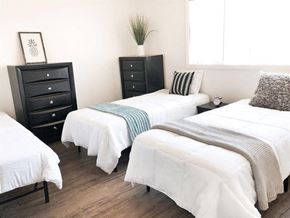 Goleta apartment for rent - Three beds with white bedspreads and pillows in a room.