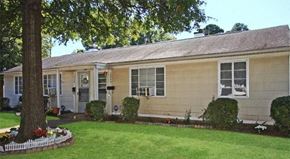 Charlotte apartment for rent - a yellow house with a yard and a tree