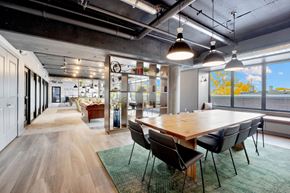 Bayonne apartment for rent - Modern conference room with large wooden table at Bay One Apartments, Bayonne, New Jersey