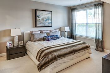 Bedroom with upholstered bed and large window