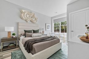 Clifton apartment for rent - A bedroom with a large bed and a wooden sculpture on the wall.