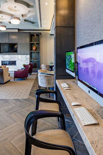Business center with computers and modern seating