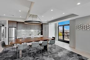 Bayonne apartment for rent - Modern dining area with wood table and patio access at Bay One Apartments, Bayonne, New Jersey