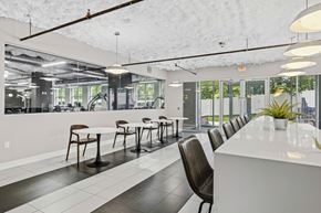 Iselin apartment for rent - A white and black dining room with a long table and chairs.