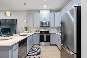 Verona apartment for rent - Modern kitchen with white countertops and stainless appliances at Highlands at Hilltop Apartments, New Jersey