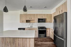 Marlton apartment for rent - A modern kitchen with wooden cabinets and stainless steel appliances.