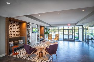 Marlton apartment for rent - a living room with a couch and chairs in front of glass doors