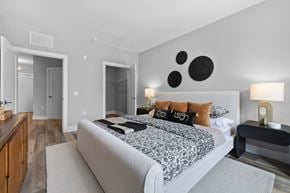 Bayonne apartment for rent - A bedroom with a large bed and a nightstand with a lamp.