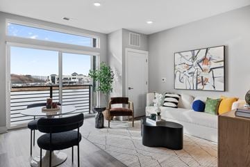 Bayonne apartment for rent - A living room with a couch, chairs, and a large painting on the wall.
