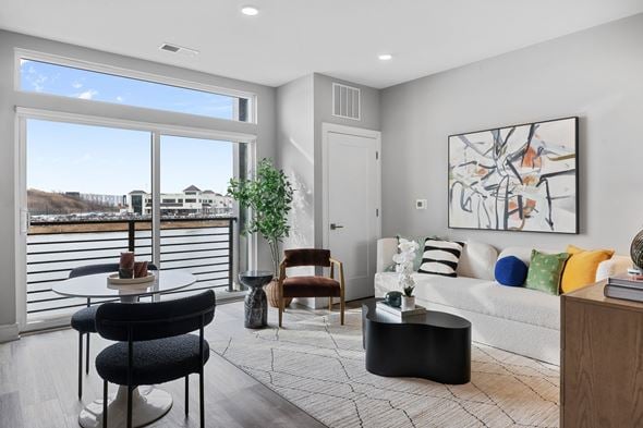 Bayonne apartment for rent - A living room with a couch, chairs, and a large painting on the wall.