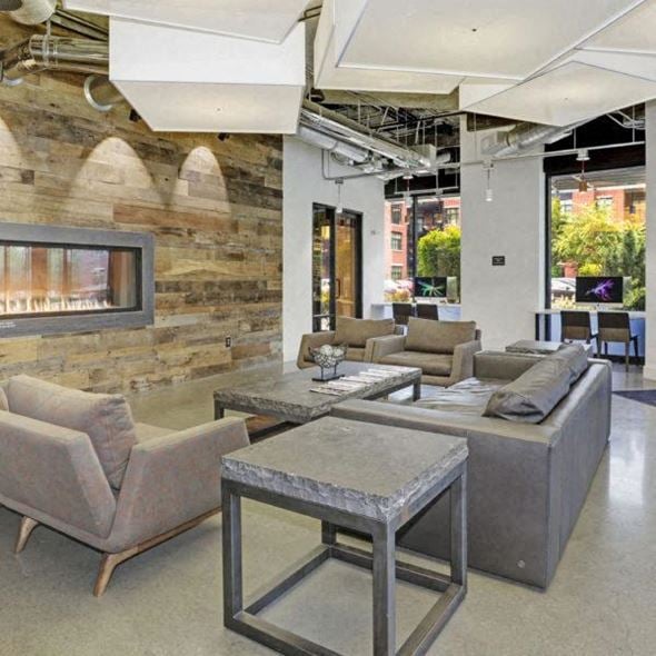 Englewood apartment for rent - a living room with couches and tables and a fireplace