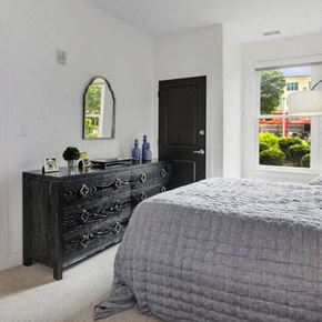Englewood apartment for rent - a bedroom with a bed and a black dresser