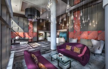 Weehawken apartment for rent - a living room with a purple couch and a table