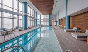 Weehawken apartment for rent - Indoor pool with lounge seating and windows at RiverParc Apartments, Weehawken, 07086