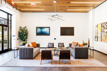 Montvale apartment for rent - A living room with a grey couch and a wooden table.
