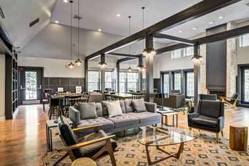 Pomona apartment for rent - A modern living room with a grey sofa and a glass coffee table.