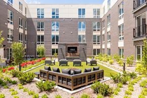 Allendale apartment for rent - an outdoor area with a couch and chairs in front of an apartment building