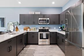 Allendale apartment for rent - a modern kitchen with stainless steel appliances and black cabinets