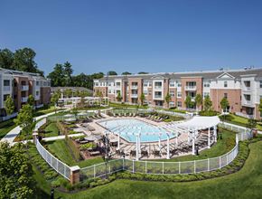 Verona apartment for rent - Aerial view of pool courtyard with white pergola and landscaping at Highlands at Hilltop Apartments, Verona, NJ