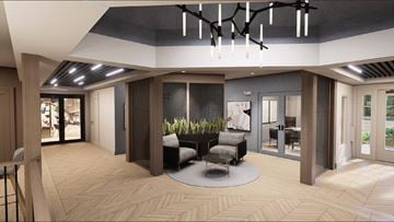 Pomona apartment for rent - A modern living room with a circular rug and a large chandelier.