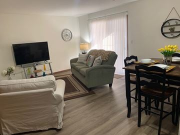 Wyoming apartment for rent - a living room and dining room with a couch and a tv