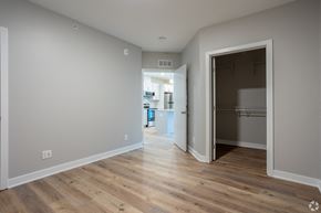 Grand Rapids apartment for rent - A room with a wooden floor and a doorway leading to another room.