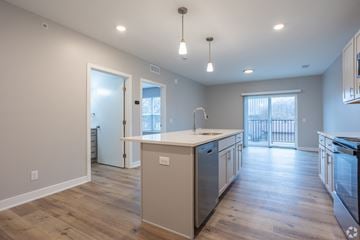 Grand Rapids apartment for rent - A kitchen with a white counter top and wooden floors.