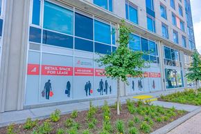 Ottawa apartment for rent - the facade of a building with retail space for lease signage