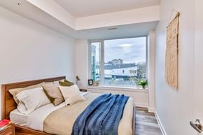 Ottawa apartment for rent - a bedroom with a bed and a large window