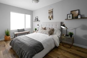 Kamloops apartment for rent - A bedroom with a large bed and a window.