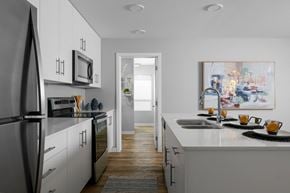 Kamloops apartment for rent - A modern kitchen with white cabinets and a refrigerator.