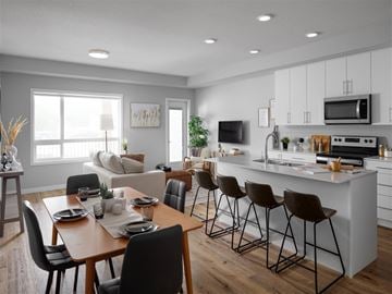 Kelowna apartment for rent - A modern kitchen with a dining table set for four.