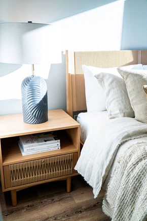 Colwood apartment for rent - A bedroom with a bed, nightstand, and lamp.