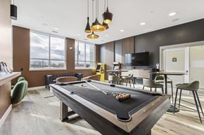 Kitchener apartment for rent - A pool table in a room with a television and chairs.