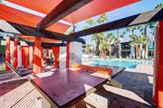 Las Vegas apartment for rent - a patio with a pool and a table and chairs at Evoq Apartment Homes, Las Vegas, NV 89169  